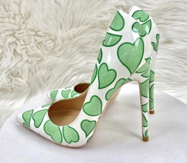 white high heeled shoes with green hearts