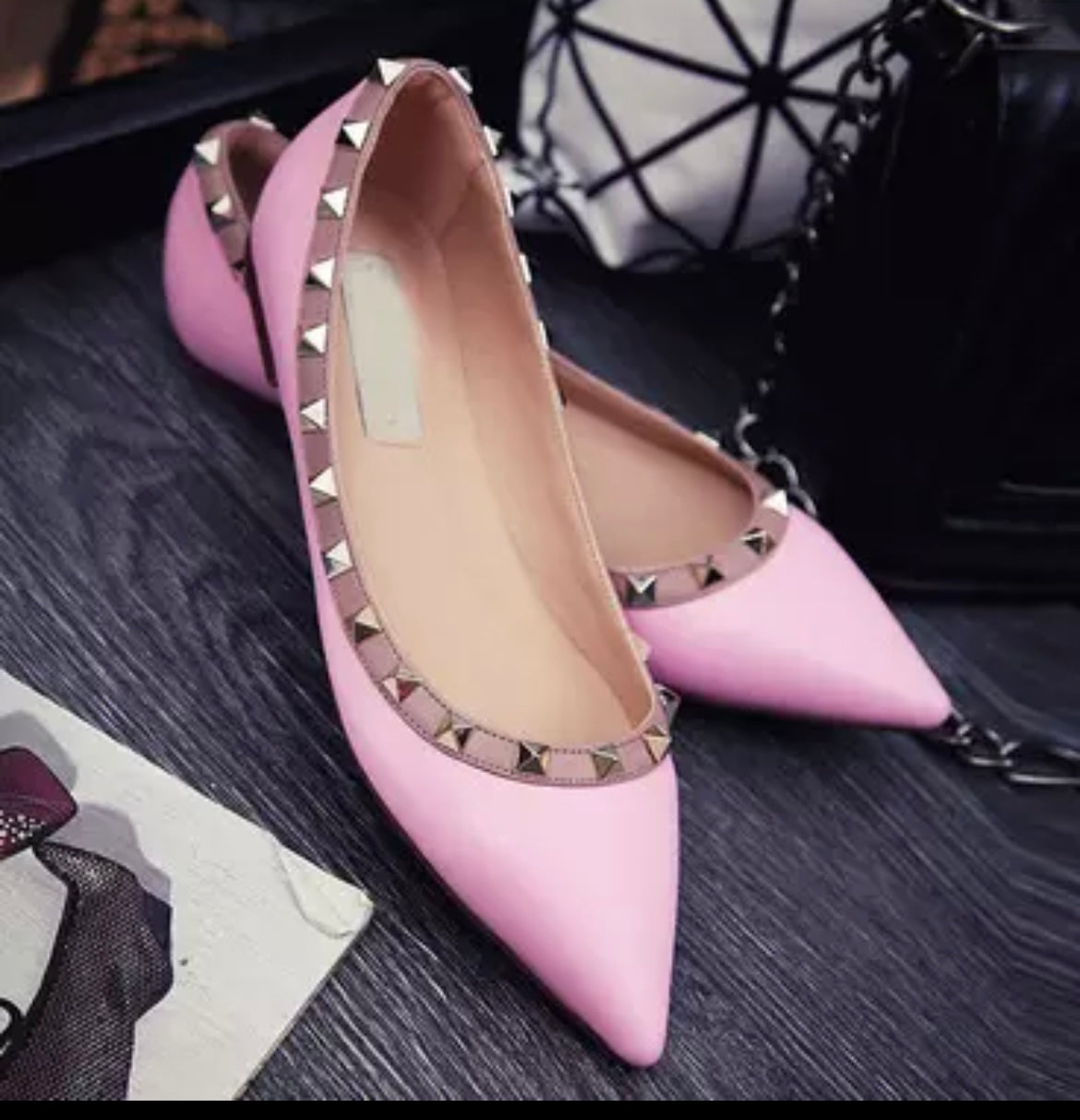 Pink flats pumps with gold rivet studs